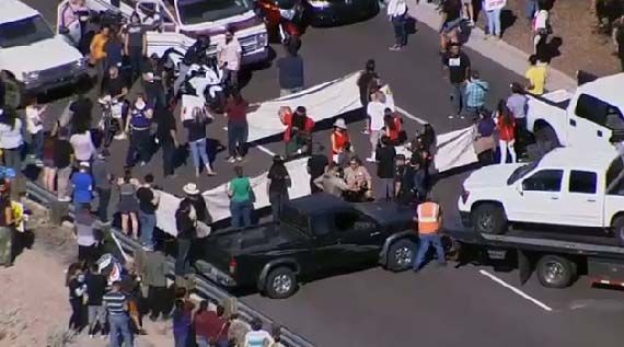 Anti-Trump protesters block a street leading into Fountain Hills. (Source: KPHO/KTVK)