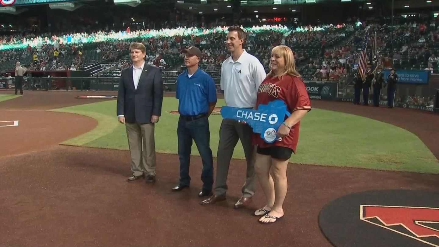 Kristyn Weed received a ceremonial key to her new house in Tucson. (Source: KPHO/KTVK)