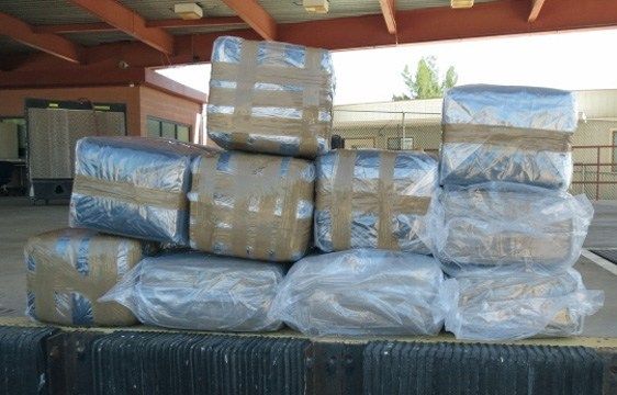 On Monday, July 4, a CBP working dog helped his human counterparts find more than 242 pounds of marijuana worth about $121,000 packed in suitcases stashed in the rear cargo area of a Hyundai SUV. (Source: Customs and Border Patrol)